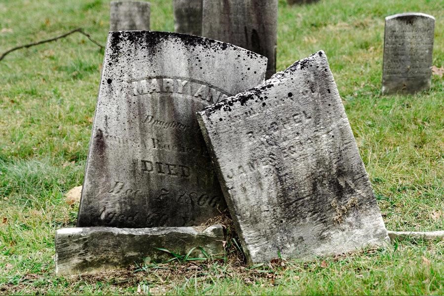 Few limestone headstones in a cemetery