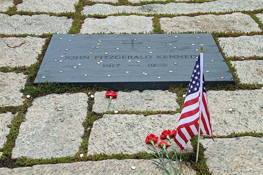 Headstone next to an American flag