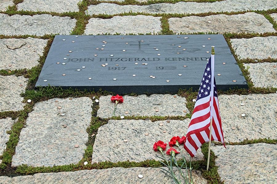 Headstone next to an American flag