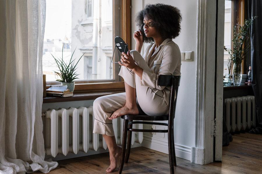 Lady in a cream-colored pajamas set on a chair