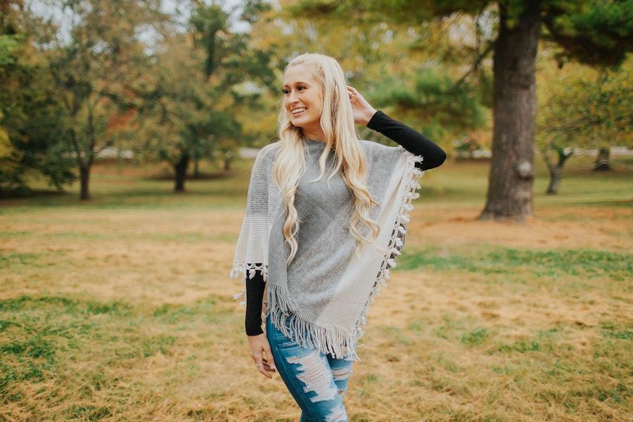 Lady in a gray-colored rustic poncho