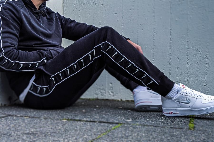 Man posing with paneled track pants