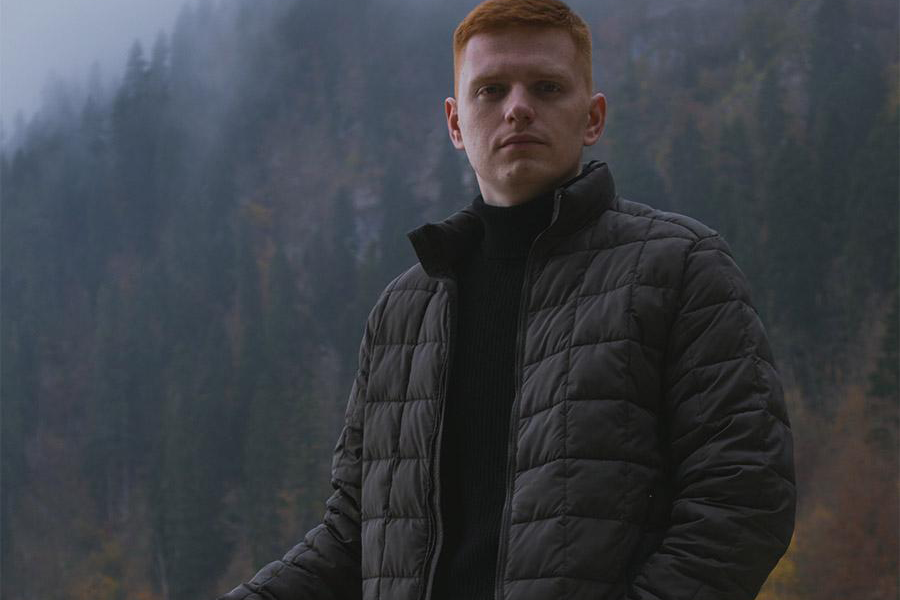 Man wearing an army green high-tech insulating mid-layer jacket