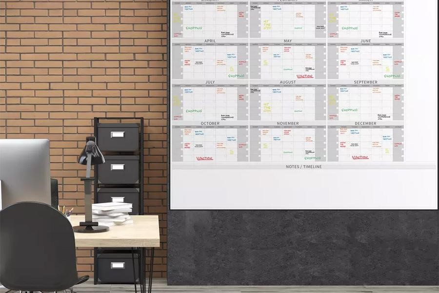 Oversized dry erase wall calendar in an office