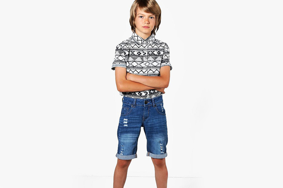 Tween posing with straight-leg denim shorts