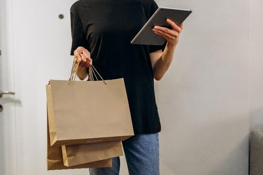 Woman holding kraft paper shopping bag