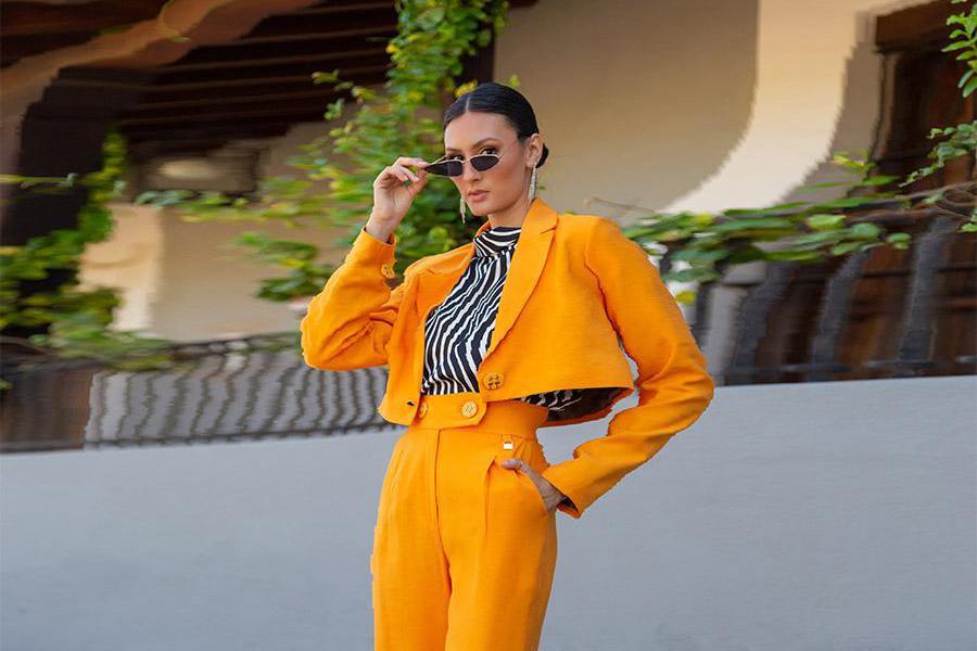 Woman wearing an orange cropped reworked suit