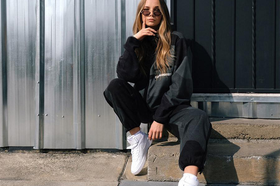 Young woman rocking a black sweatpant and sweatshirt