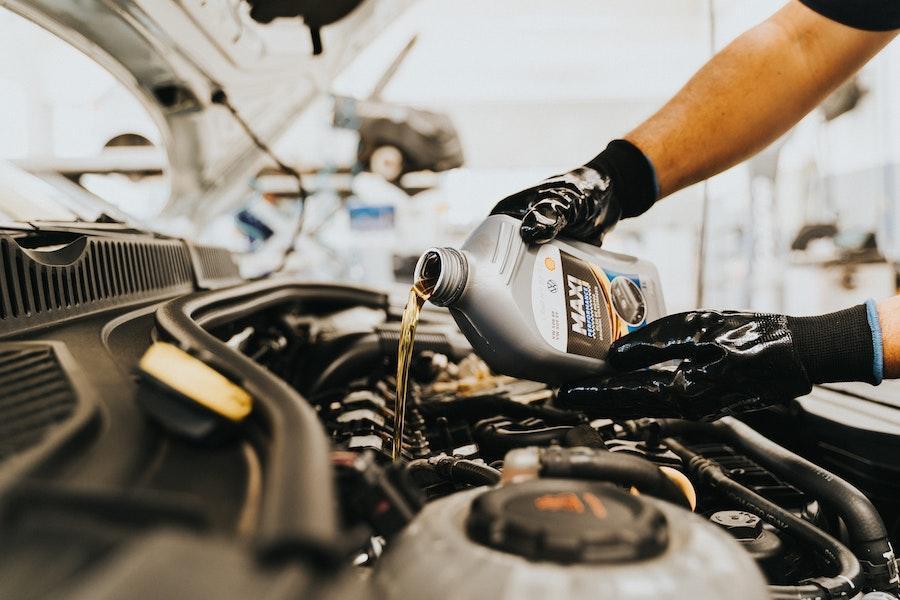 A man refilling an engine’s oil