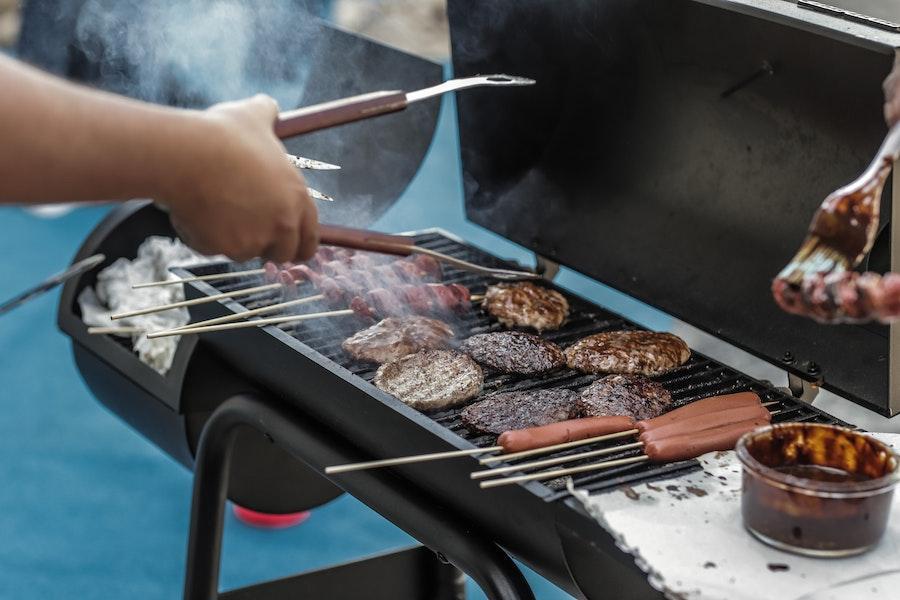 Anonymous person using a wood pellet grill