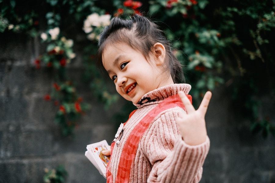 Beautiful toddler posing with a knitted cardigan