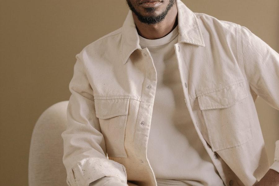 Man donning a cream-colored alt suit