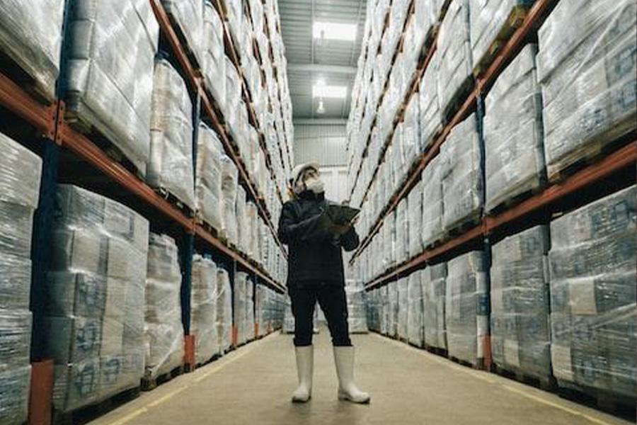 Man inspecting and recording stored product information