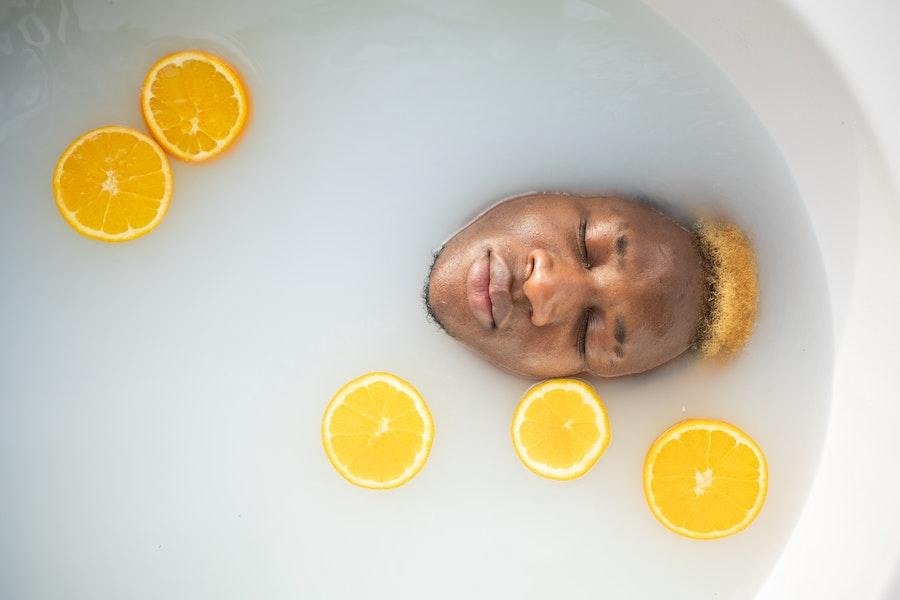 Man submerged in a bath with lemons