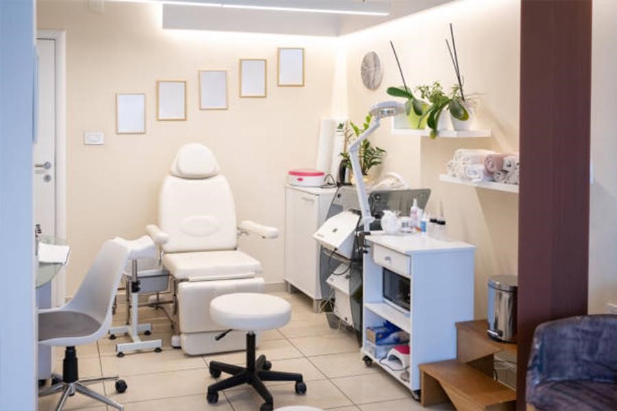 White heated massage bed in upright position inside beauty salon