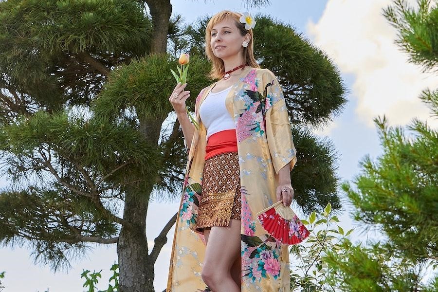 Woman draping a floral robe over a classic outfit