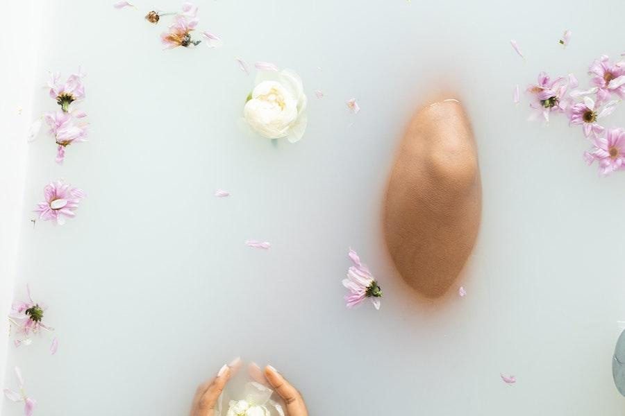 Woman slow-bathing with flowers