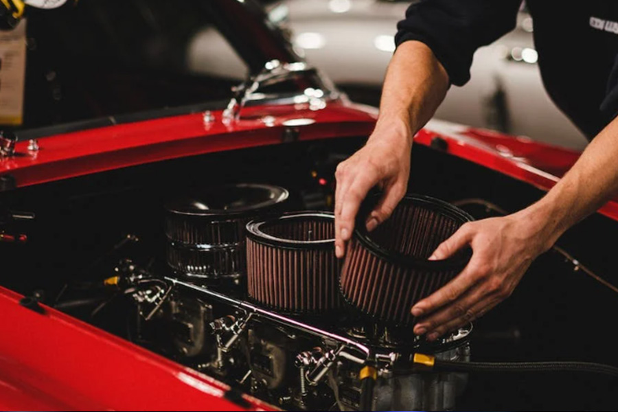 A man fixing a car's air filter