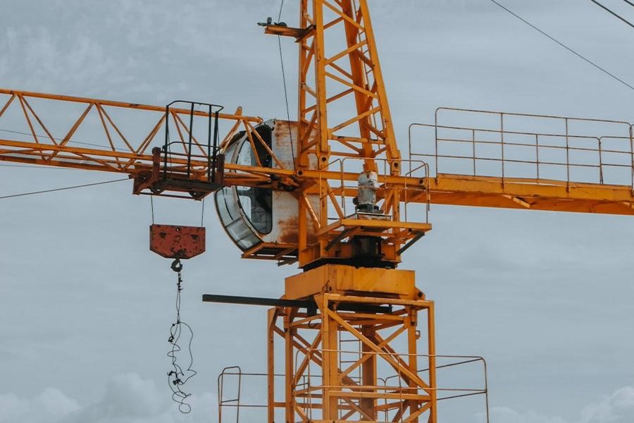 A yellow crane tower on a construction site