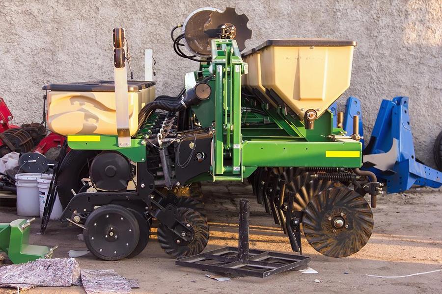 Agricultural seeder parked in a garage