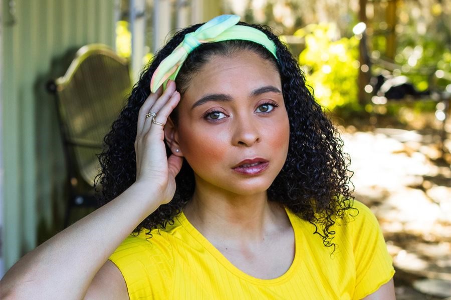 Beautiful woman posing with a scarf headband on her head