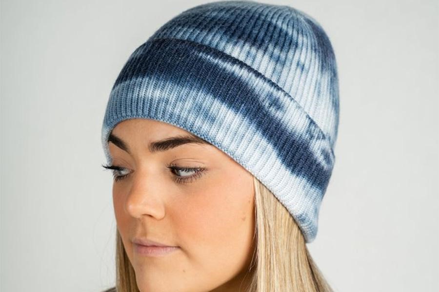 Blonde woman rocking a tie-dye hipster beanie