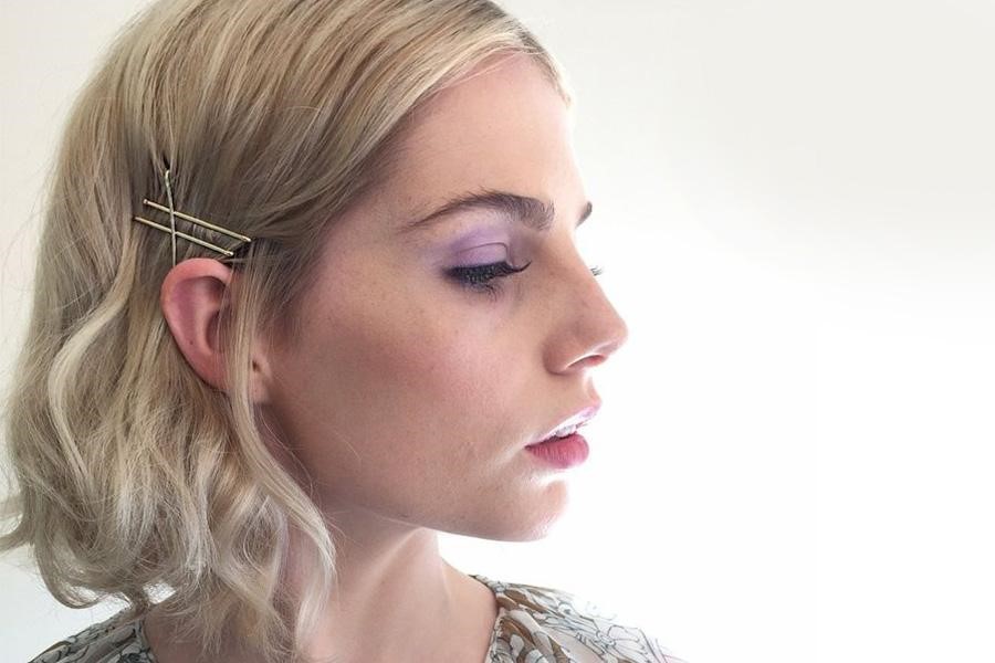 Blonde woman styling three bobby pins