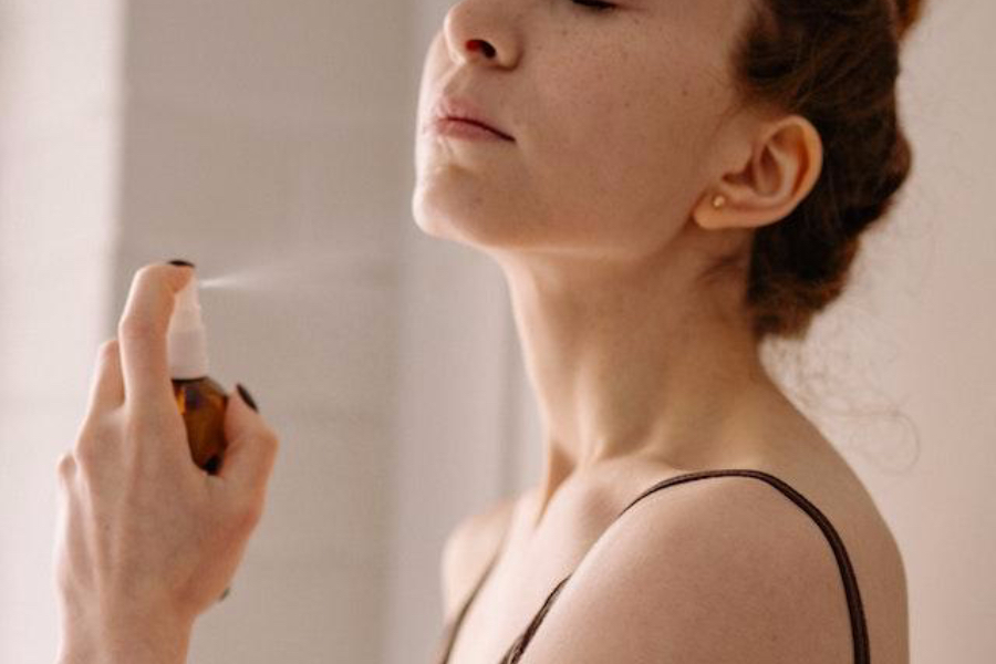 Close-up of a woman applying mist