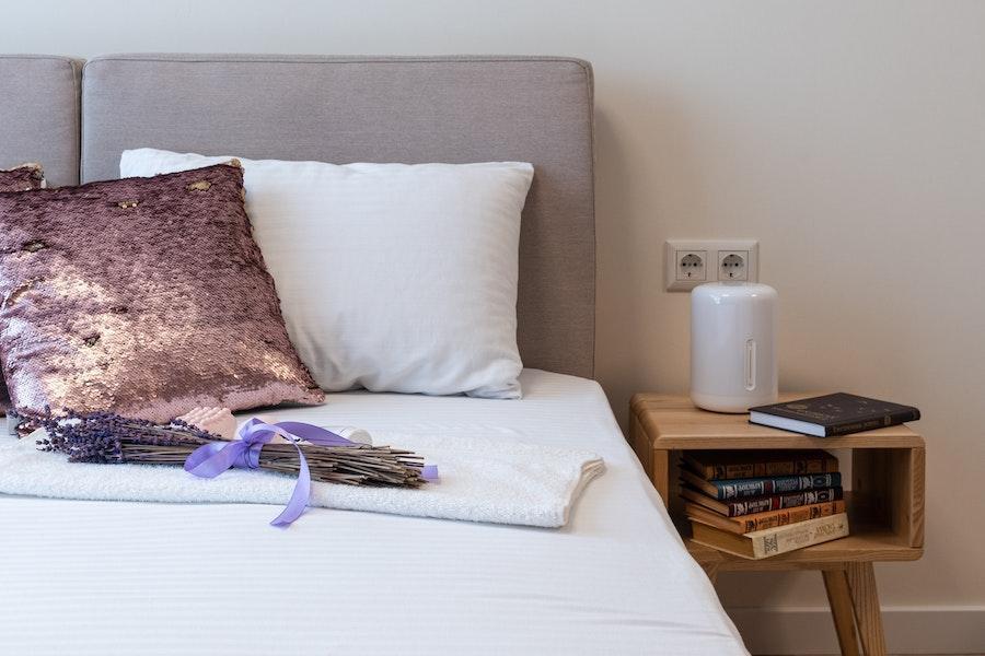 Humidifier next to a bed on a side table