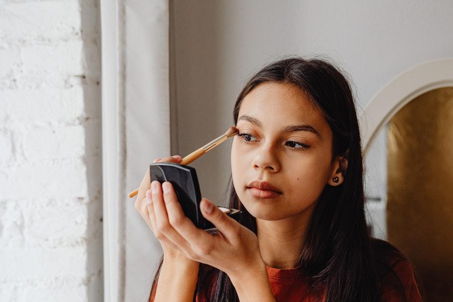 Lady using a makeup brush to apply eye shadow