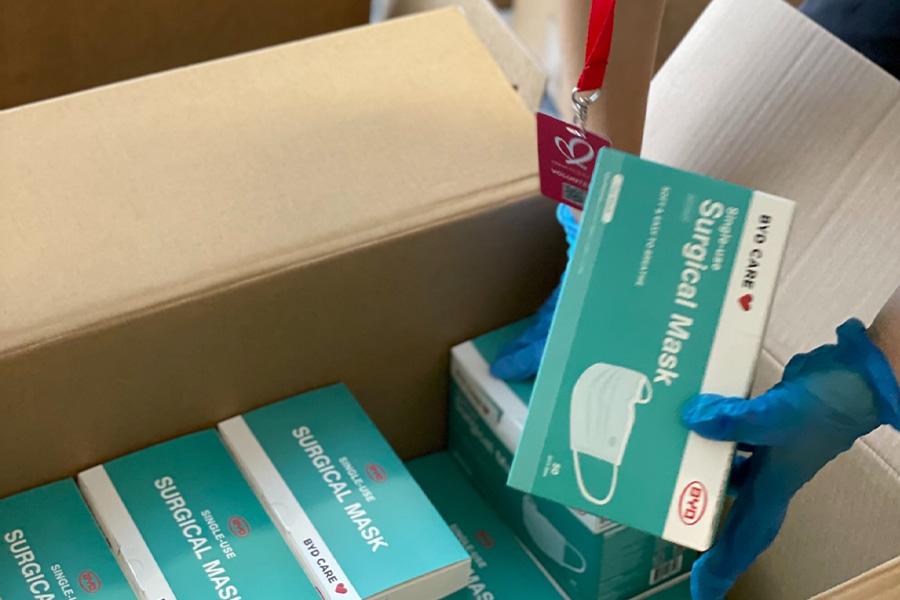 Man packing a box of hygiene products