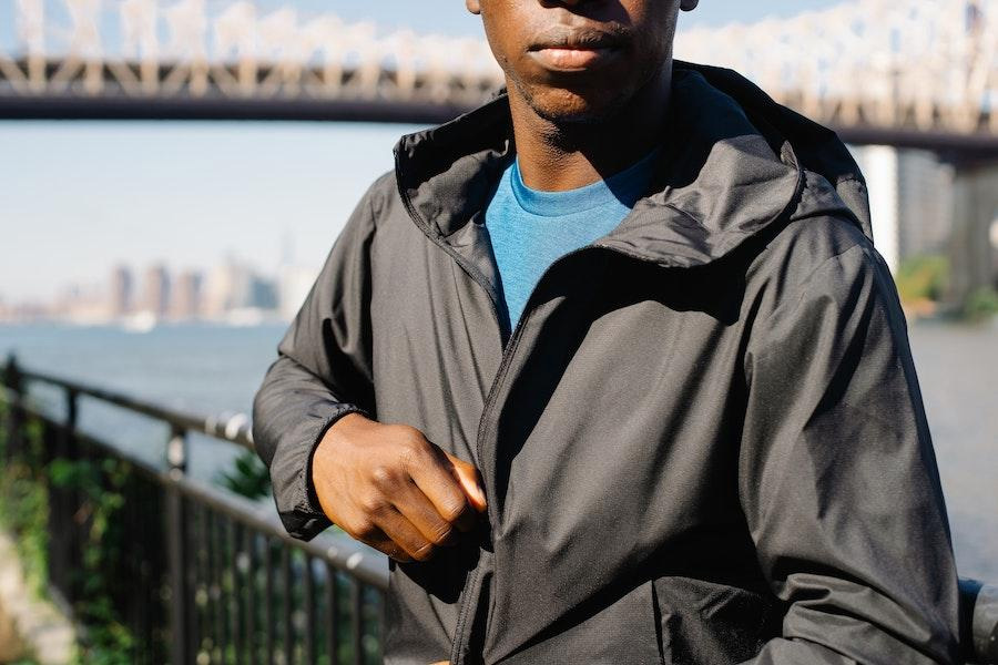 man posing in a black windbreaker