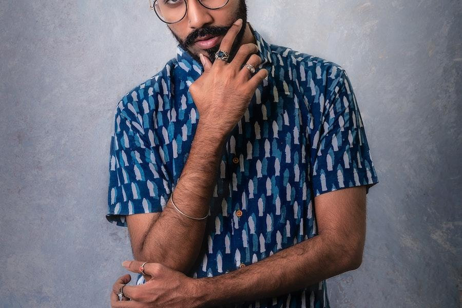 man posing in a blue resort shirt