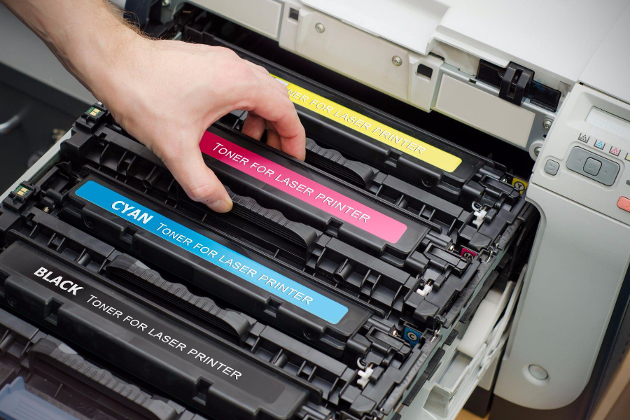 Man putting toner cartridge in a printer