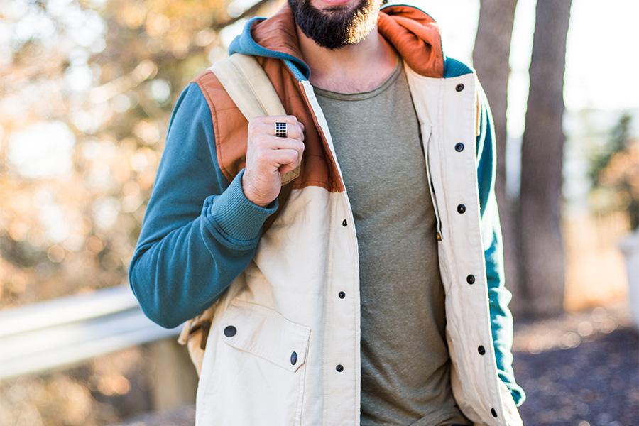 Men holding a bag while holing a summer parka