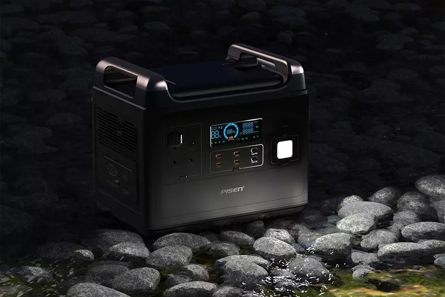 Outdoor portable power station next to stream and some rocks