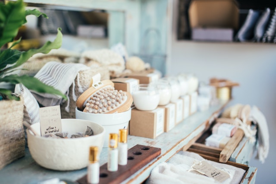 Perfume placed near bath brushes and aromatic candles