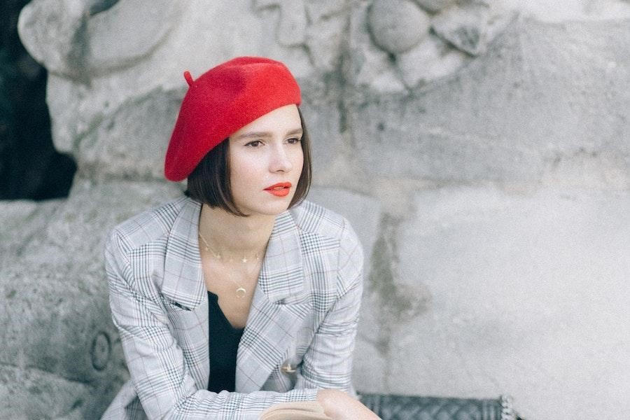 Sitting woman wearing a red beret