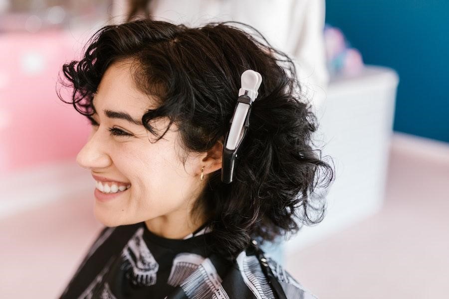 Smiling woman with a white crocodile clip