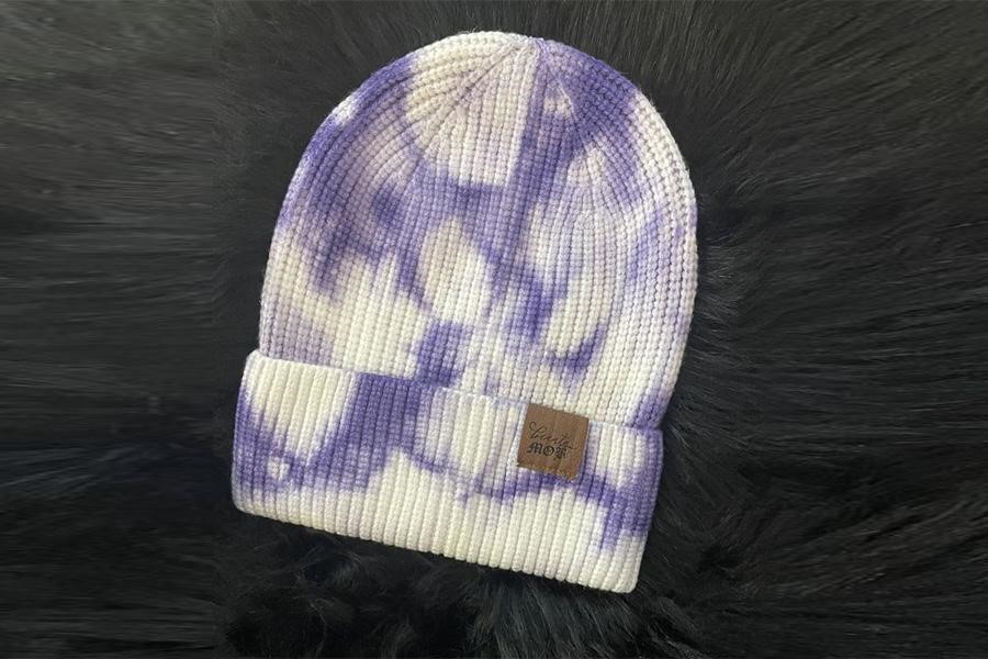 Tie-dye beanie on a furry surface