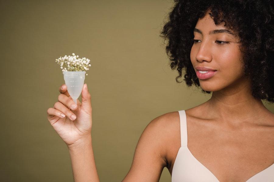 Woman holding a silicone menstruation cup