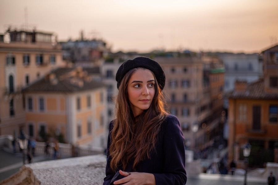 Woman looking sideways wearing a black beret