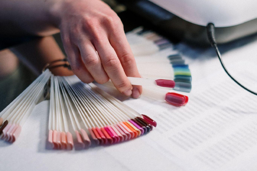 Woman picking out gel polish color.