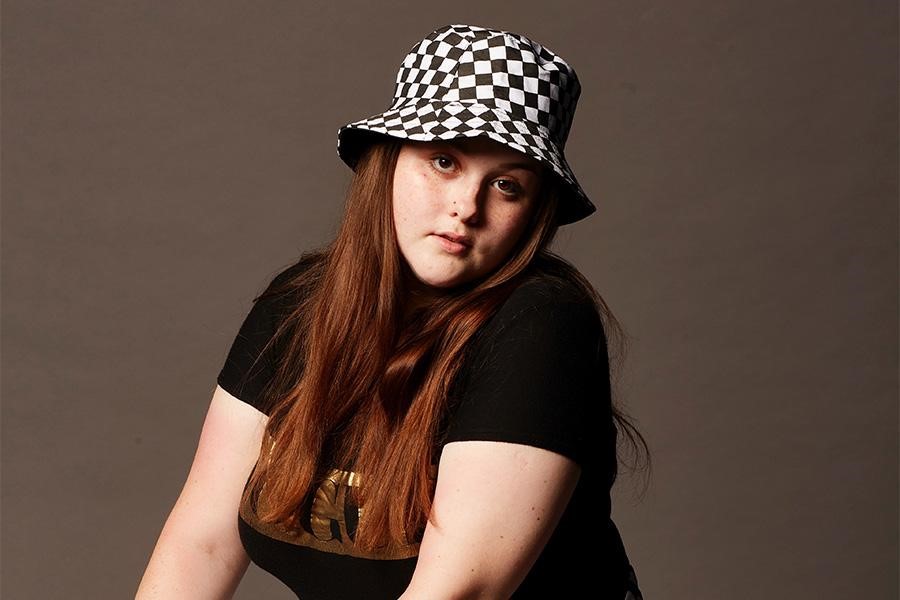 Woman posing in a checkered bucket hat