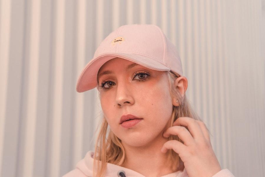 lady posing in a black trucker hat