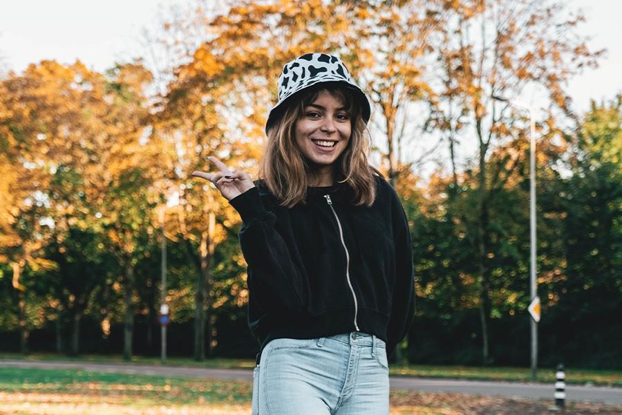 Woman posing in an animal-print bucket hat