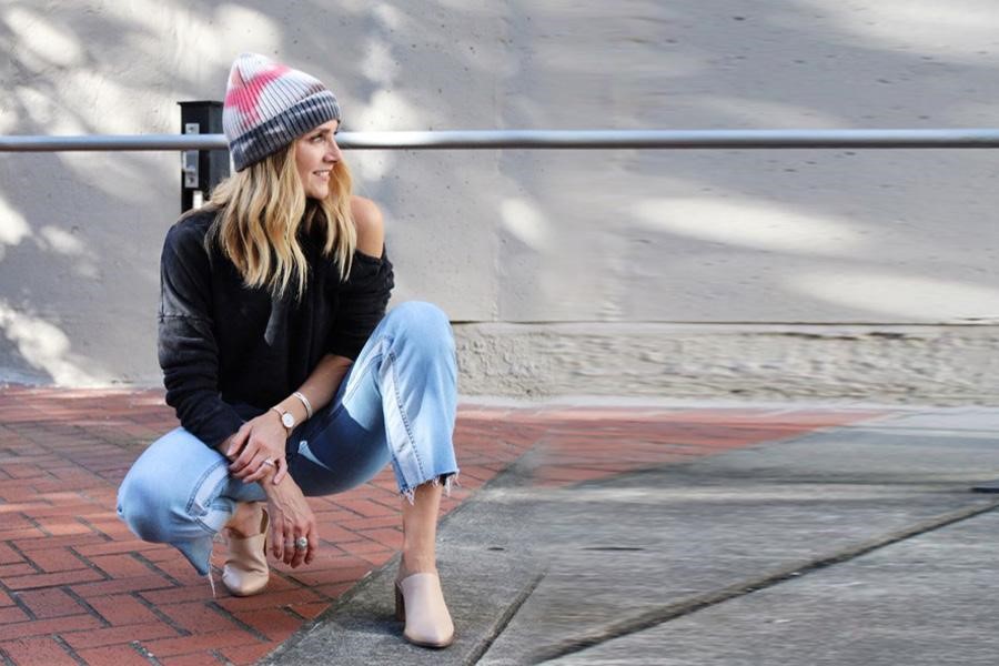 Woman posing with a tie-dye beanie