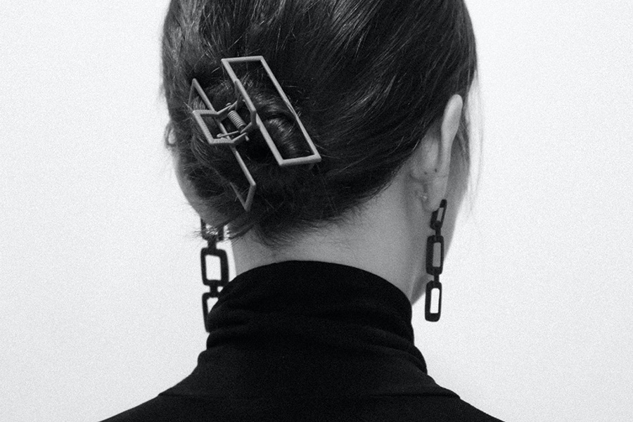 woman securing a bun with metallic hair clip