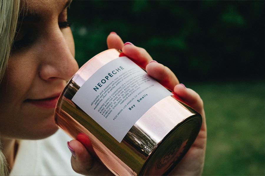 woman smelling a scented candle