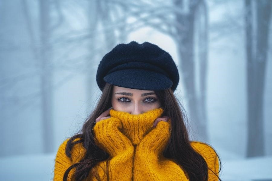 Woman wearing a black schoolboy hat